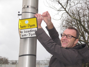 Nick from Don’t Dump on Deptford’s Heart attaches a gas diffusion tube to a street post/lamp, January 2014